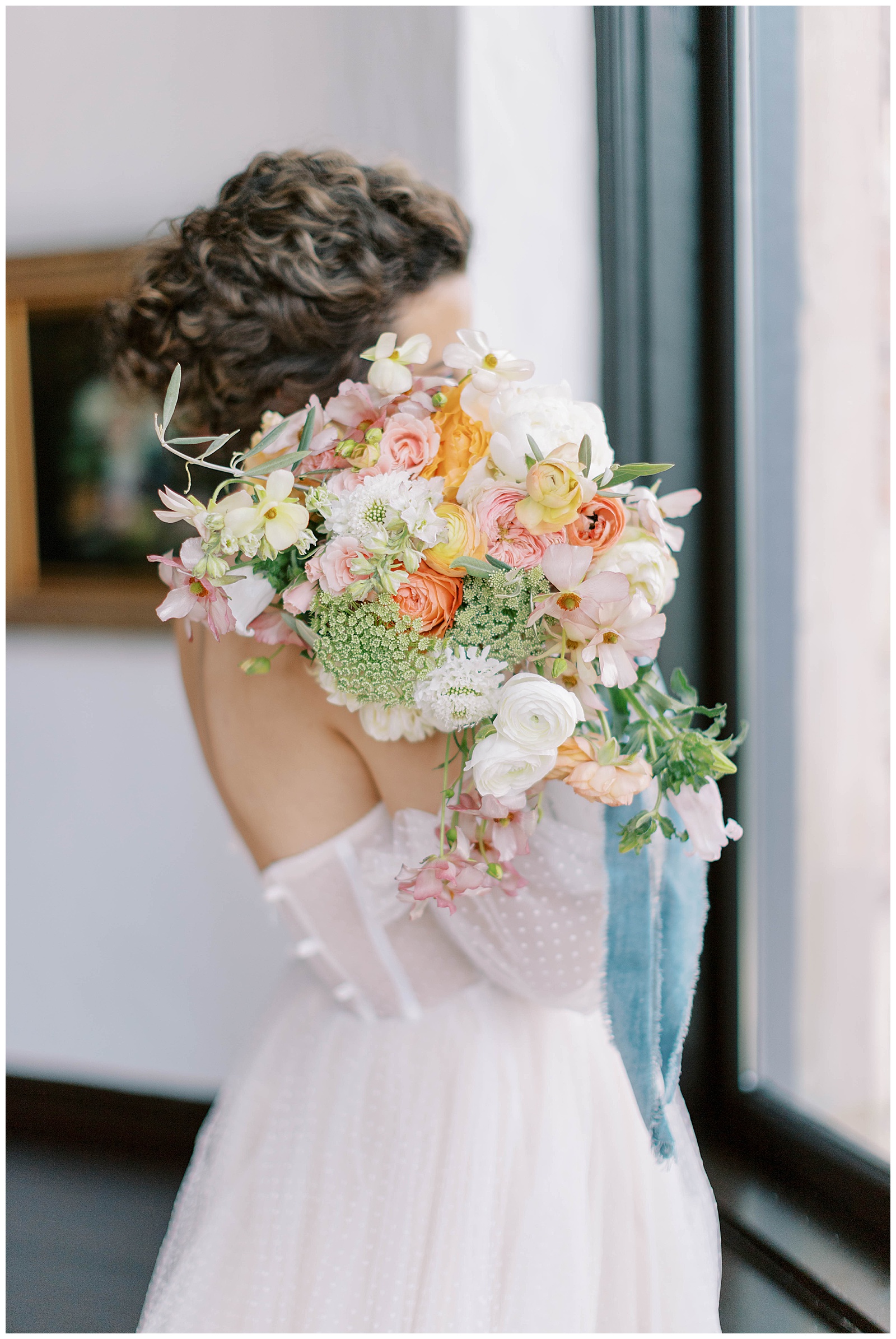bridal portrait with bouquet dusty blue with pink and orange