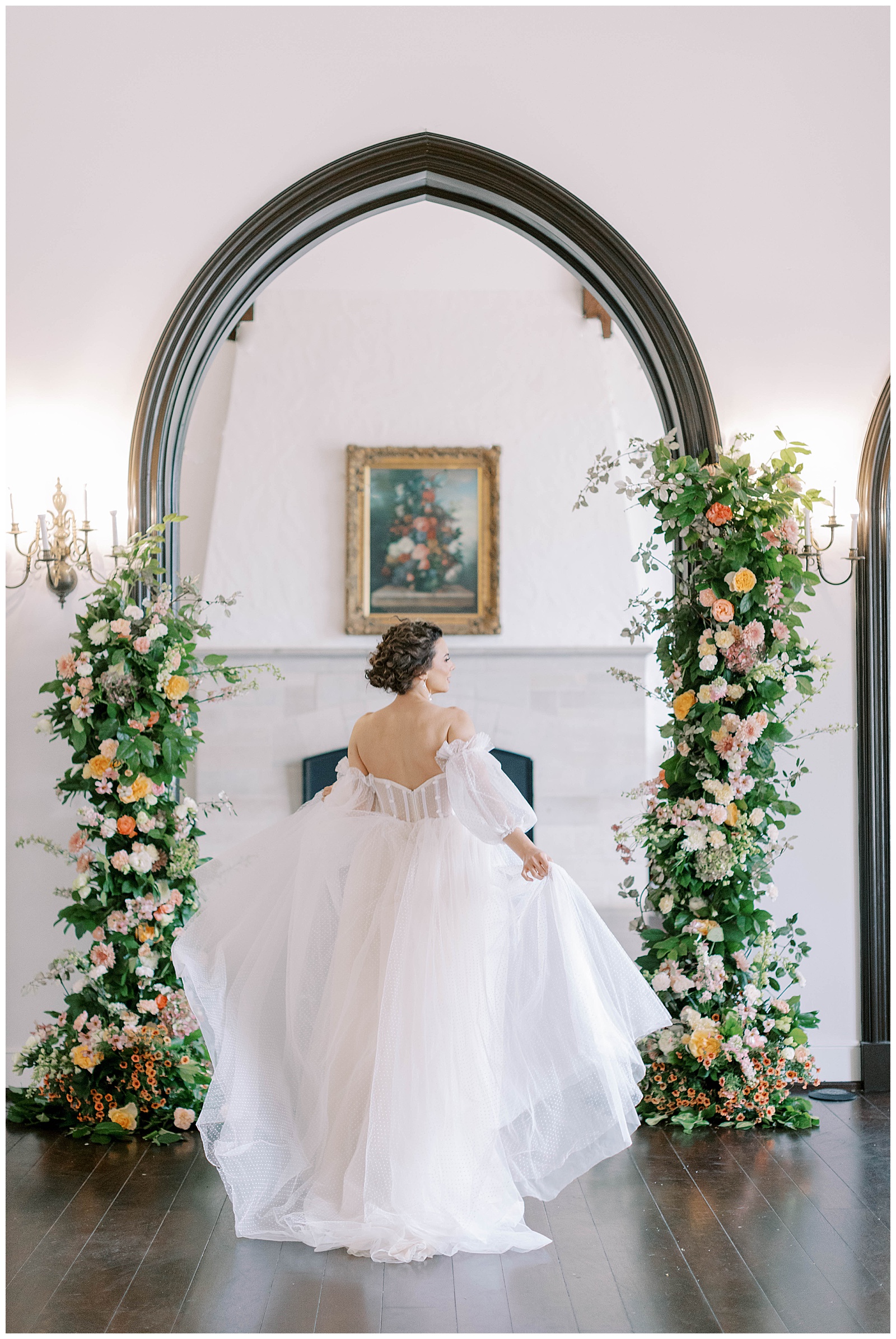 bride running through floral arches at kansas city wedding